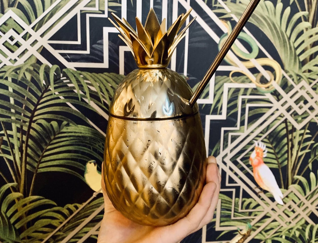 Signature golden pineapple drink vessel with botanical interior design