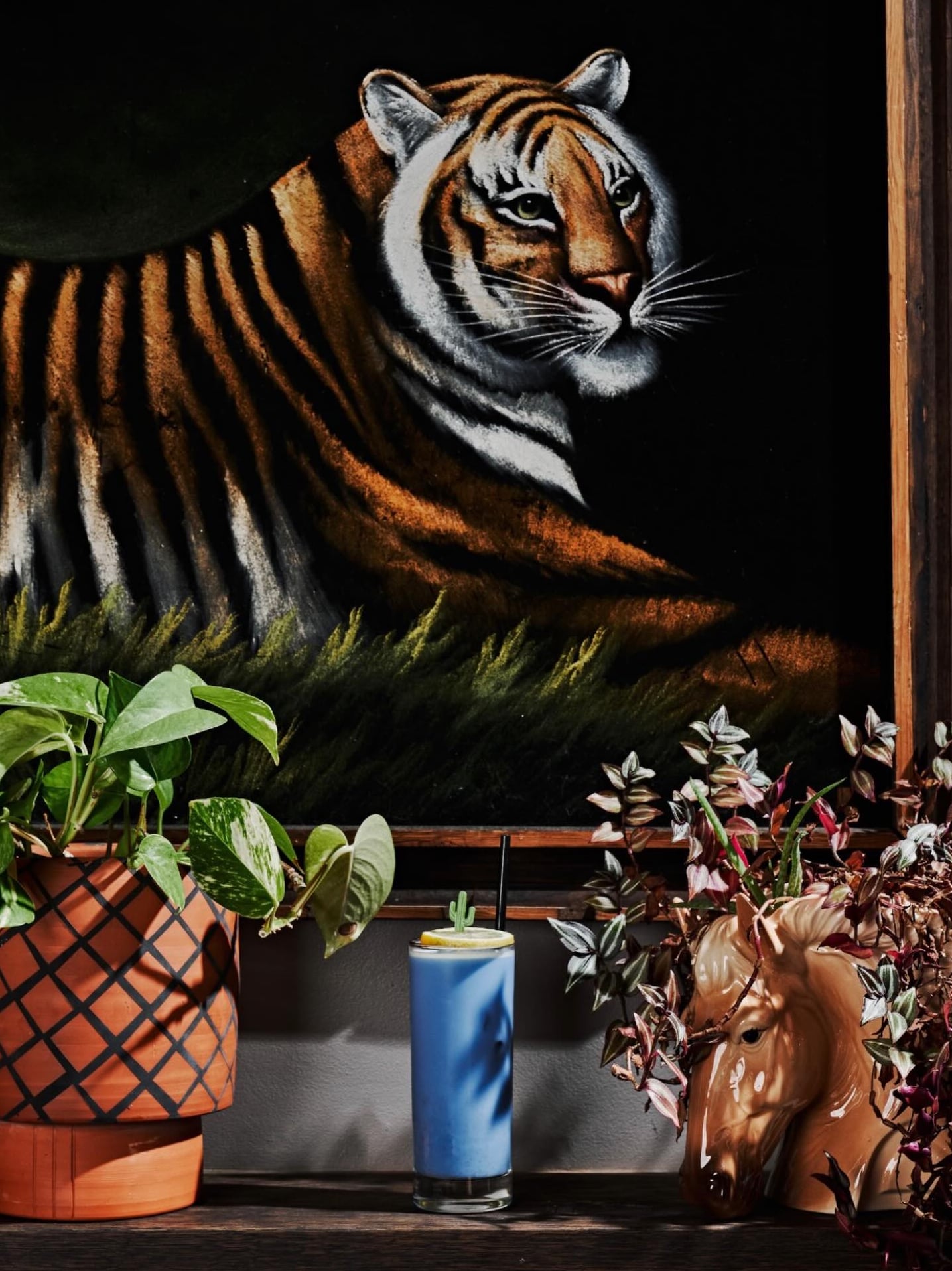 Vibrant tiger mural with tropical plants and house cocktail