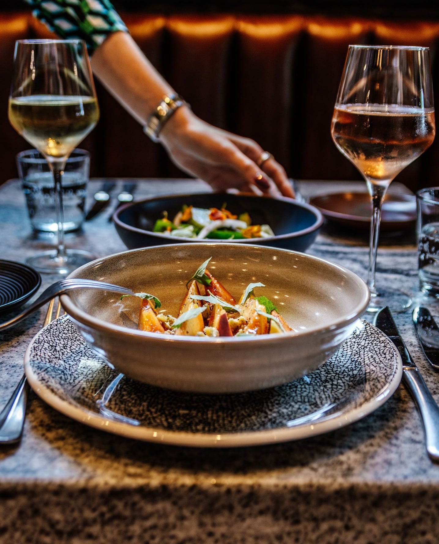Plated appetizer served with white and rosé wines