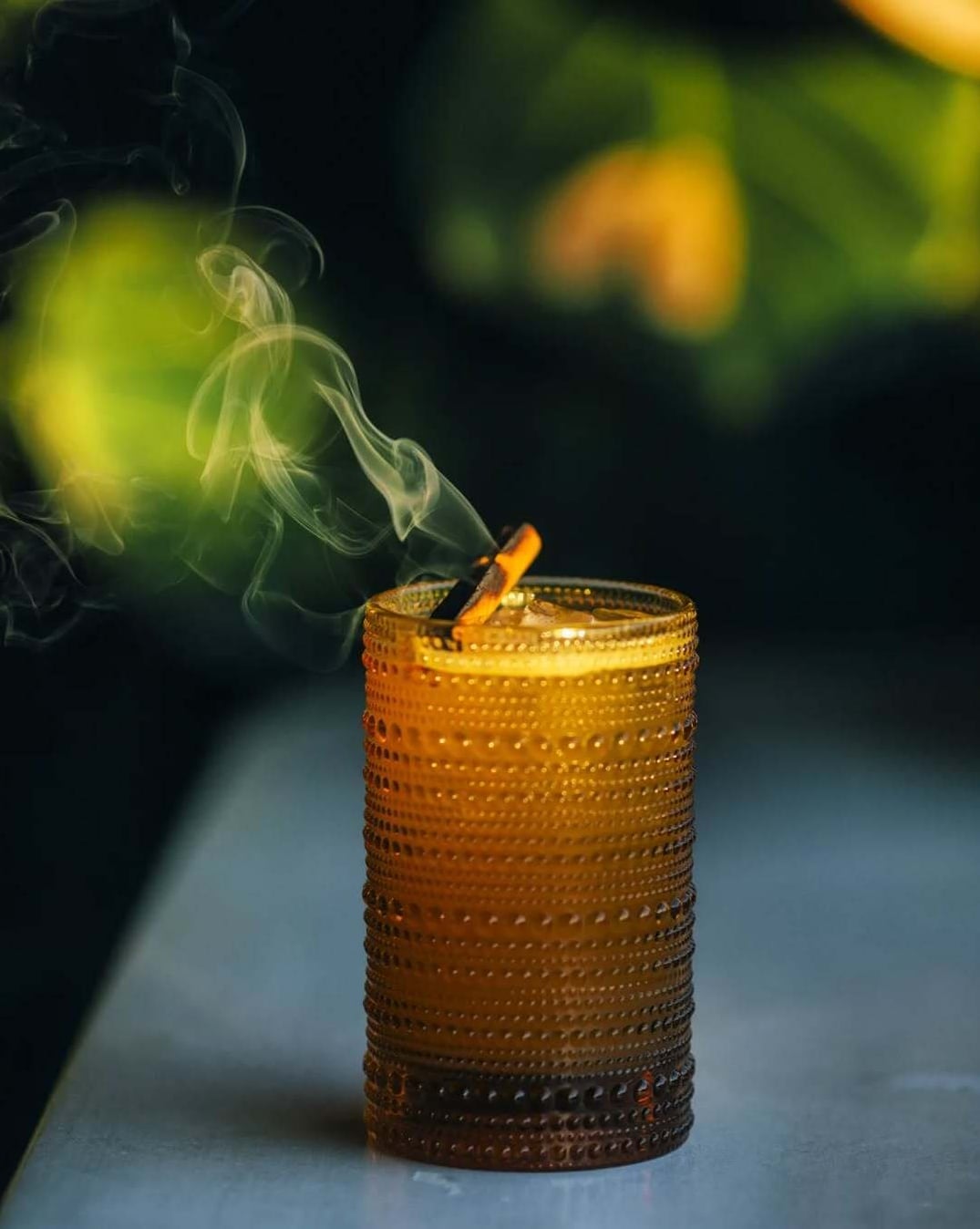 Smoked agave cocktail served in a vintage hobnail glass at Anoche