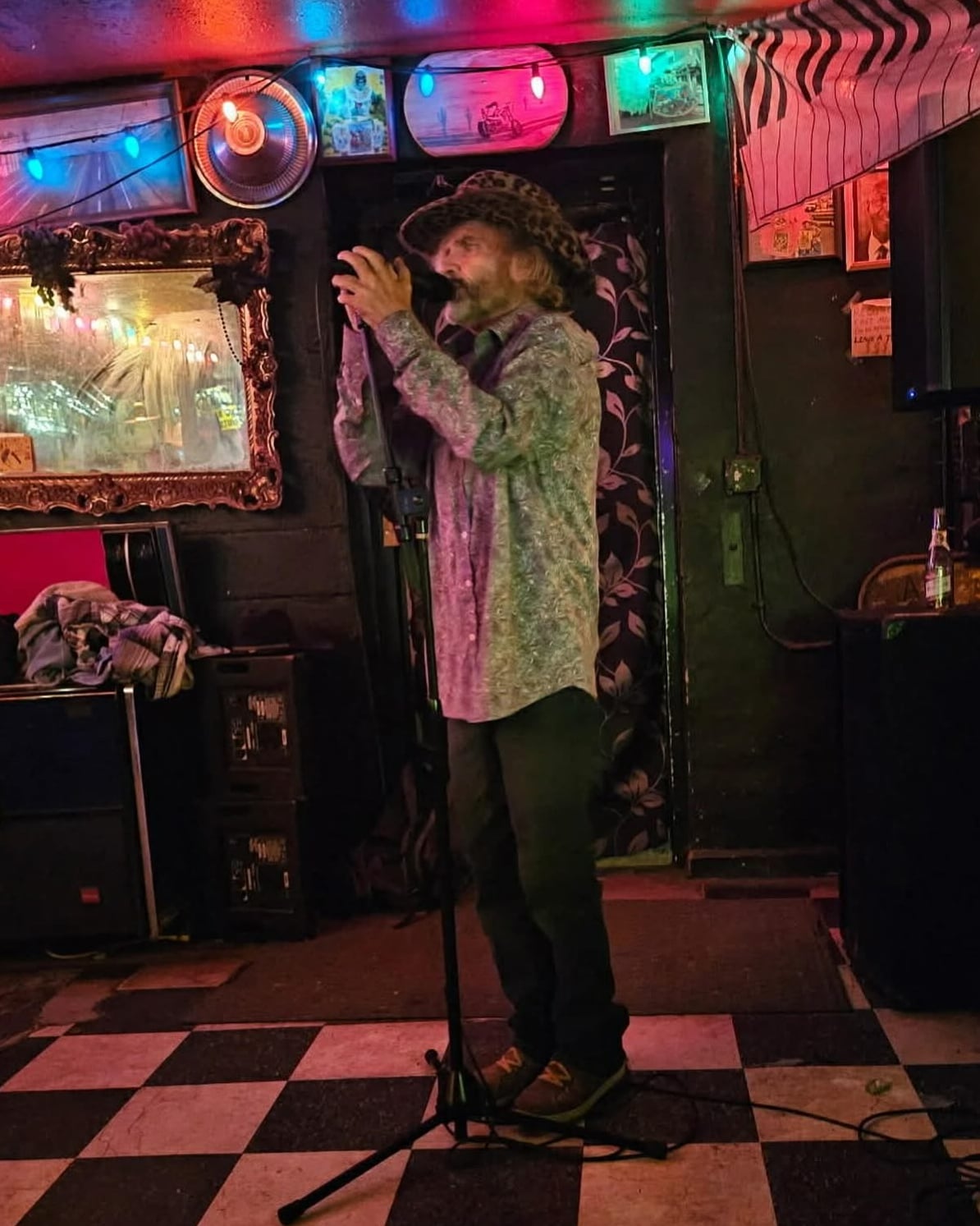 Live music performance inside the intimate venue on the signature checkered tile floor