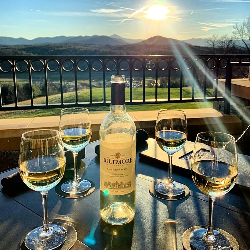 Biltmore wine and glasses on the Library Lounge patio with Blue Ridge Mountain sunset views
