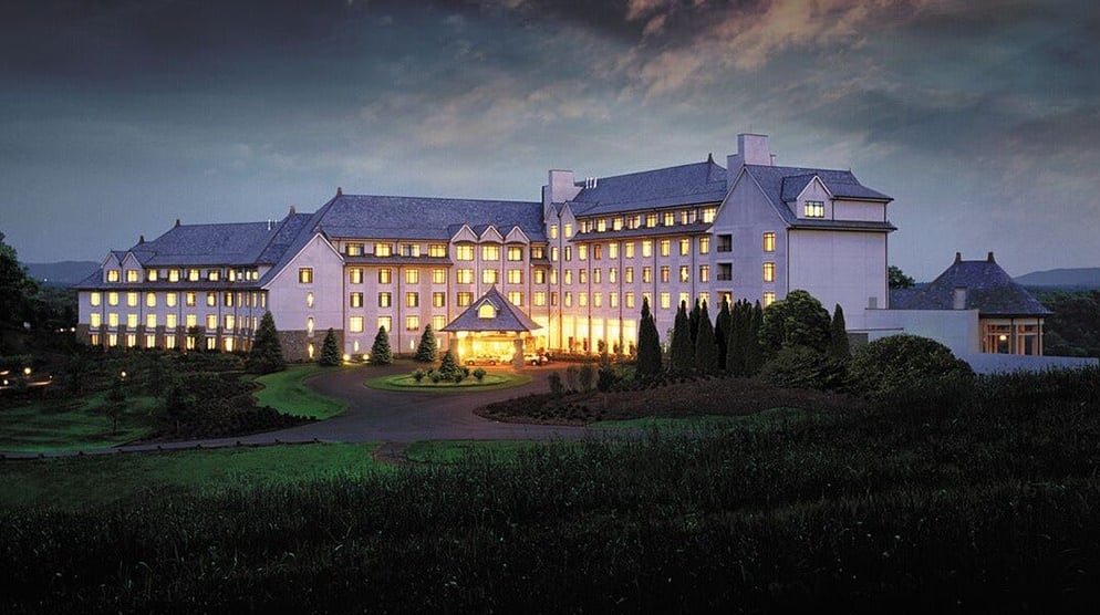 The Inn on Biltmore Estate illuminated at twilight, home of the Library Lounge