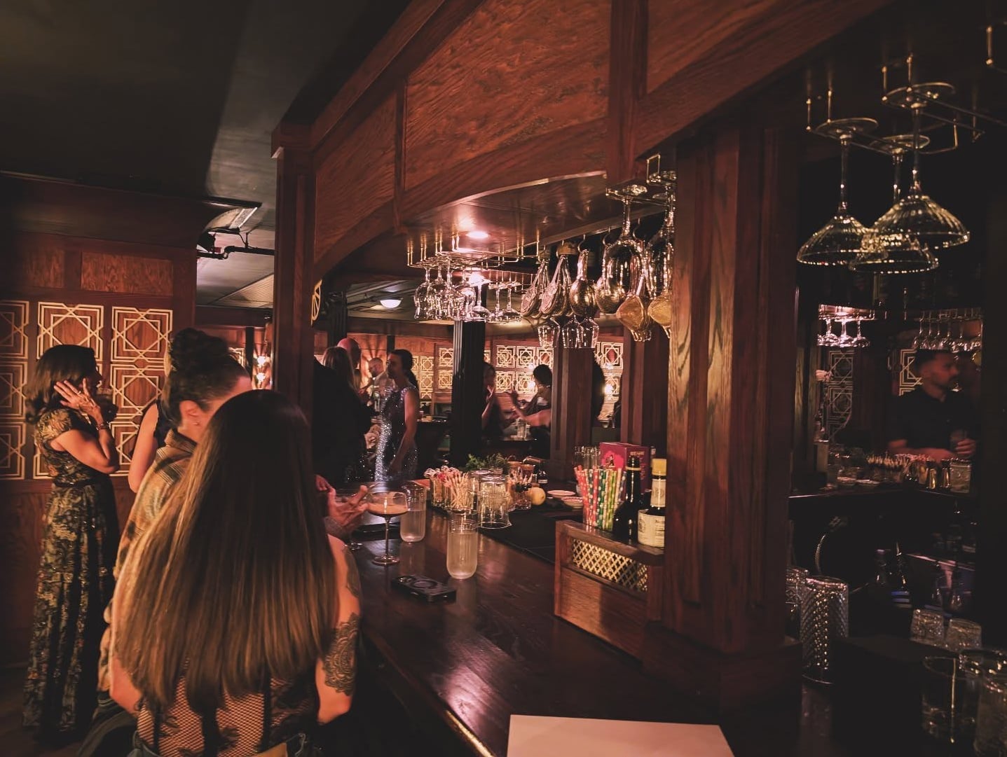 Atmospheric interior featuring dark wood paneling and classic brass detailing.