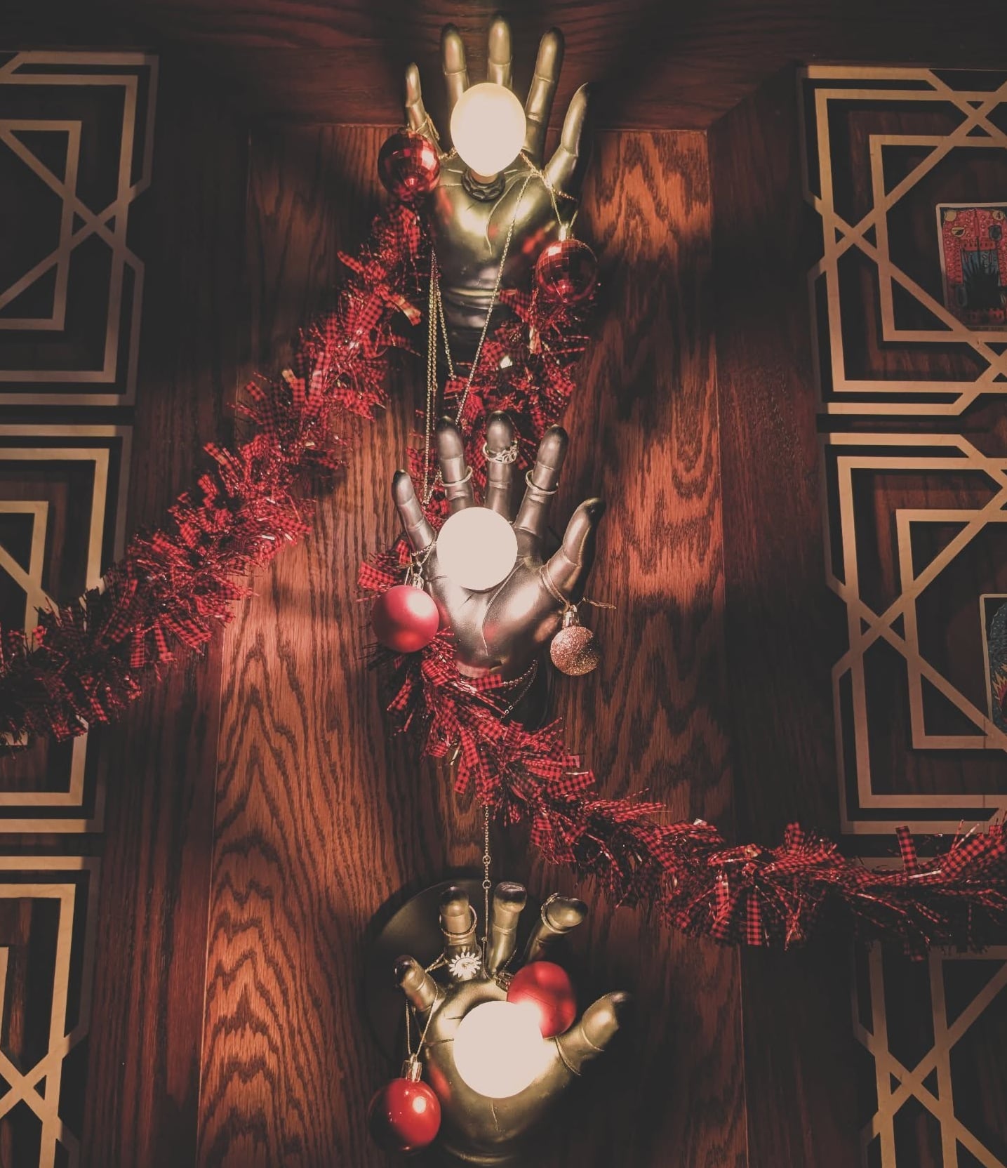 "Hand"-crafted metallic sconces add unique flair to the wood-paneled decor.