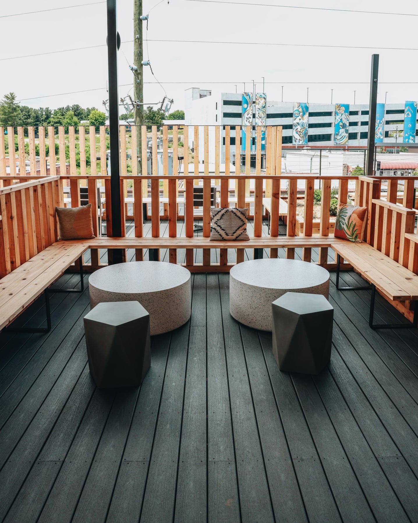 Rooftop seating area with modern built-in benches and geometric tables