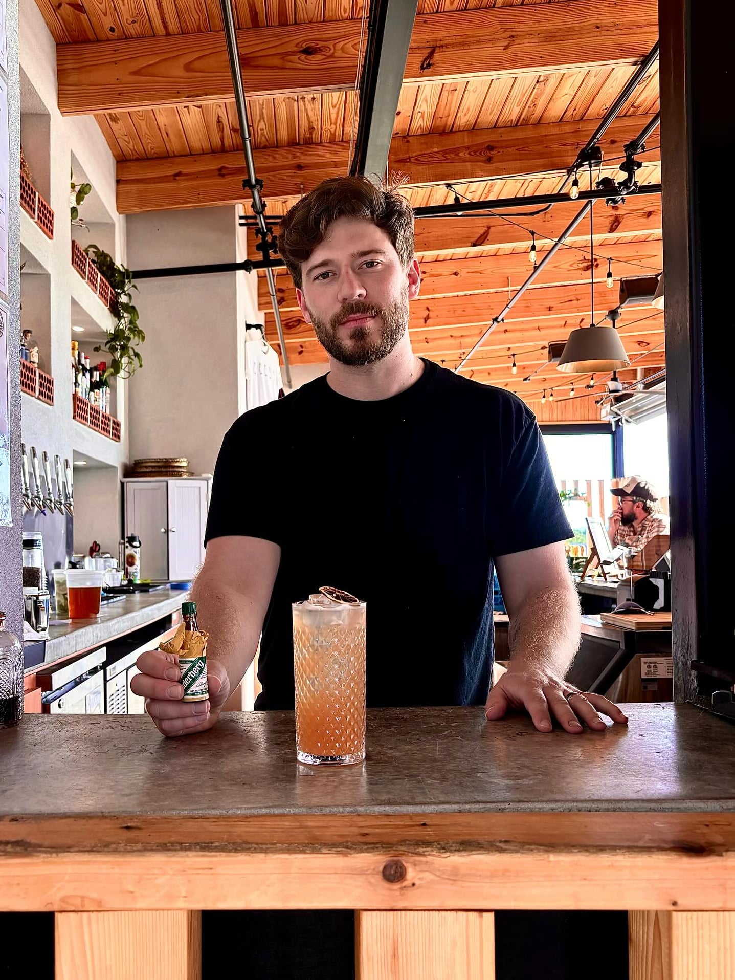 Bartender preparing cocktails at the wooden bar.