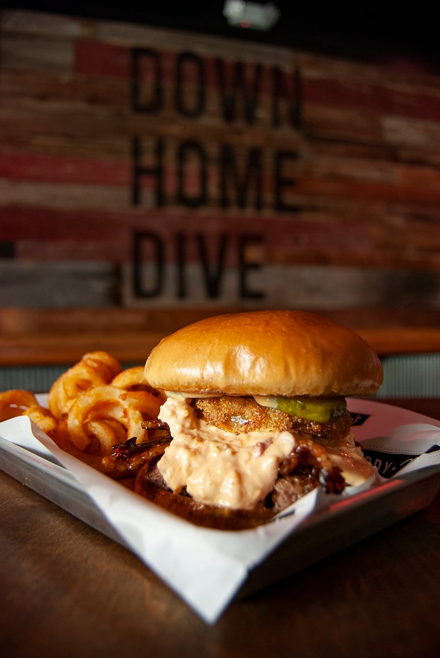 Loaded burger and curly fries at Down Home Dive