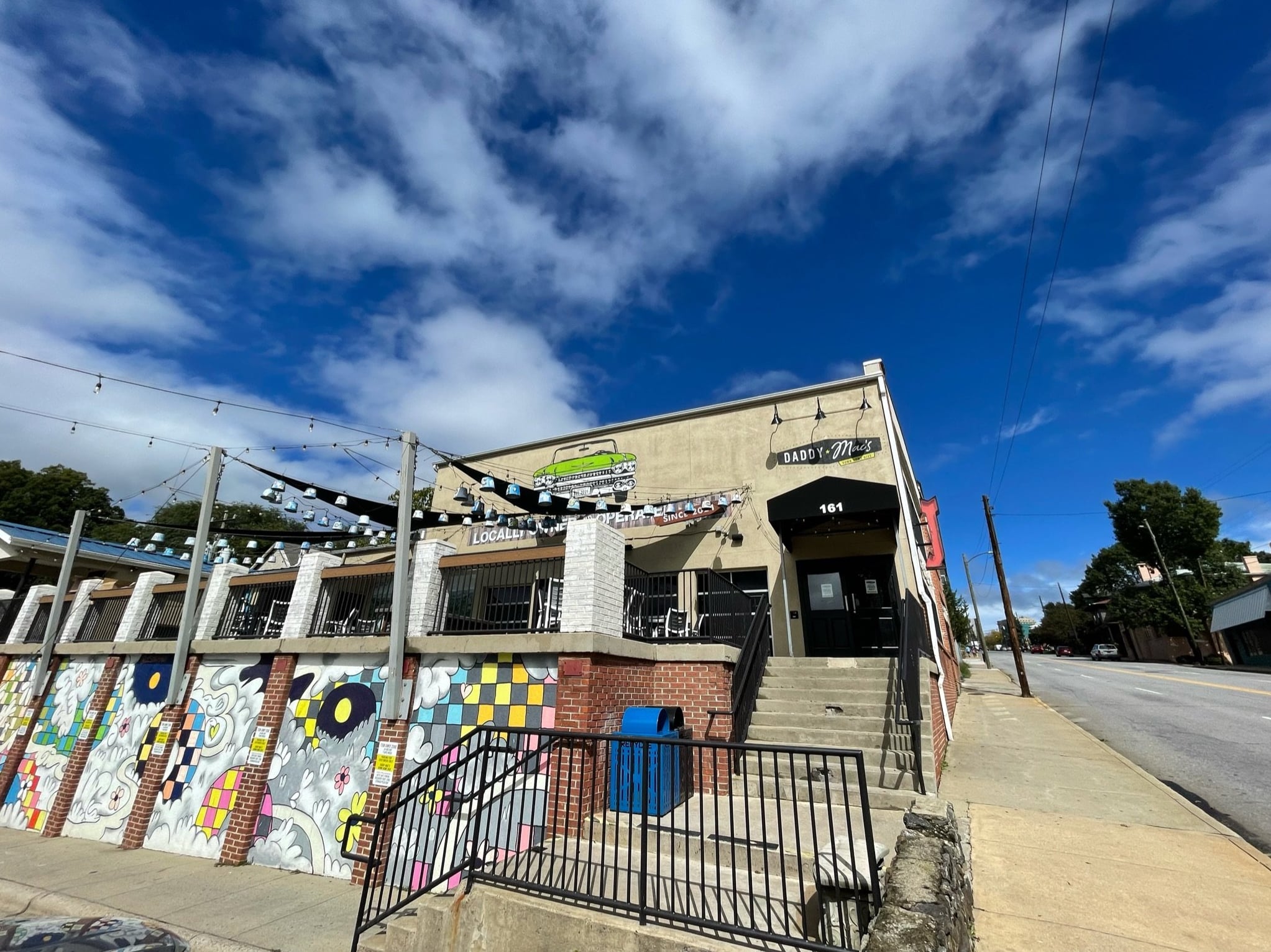 Colorful exterior facade featuring distinctive murals and venue signage.
