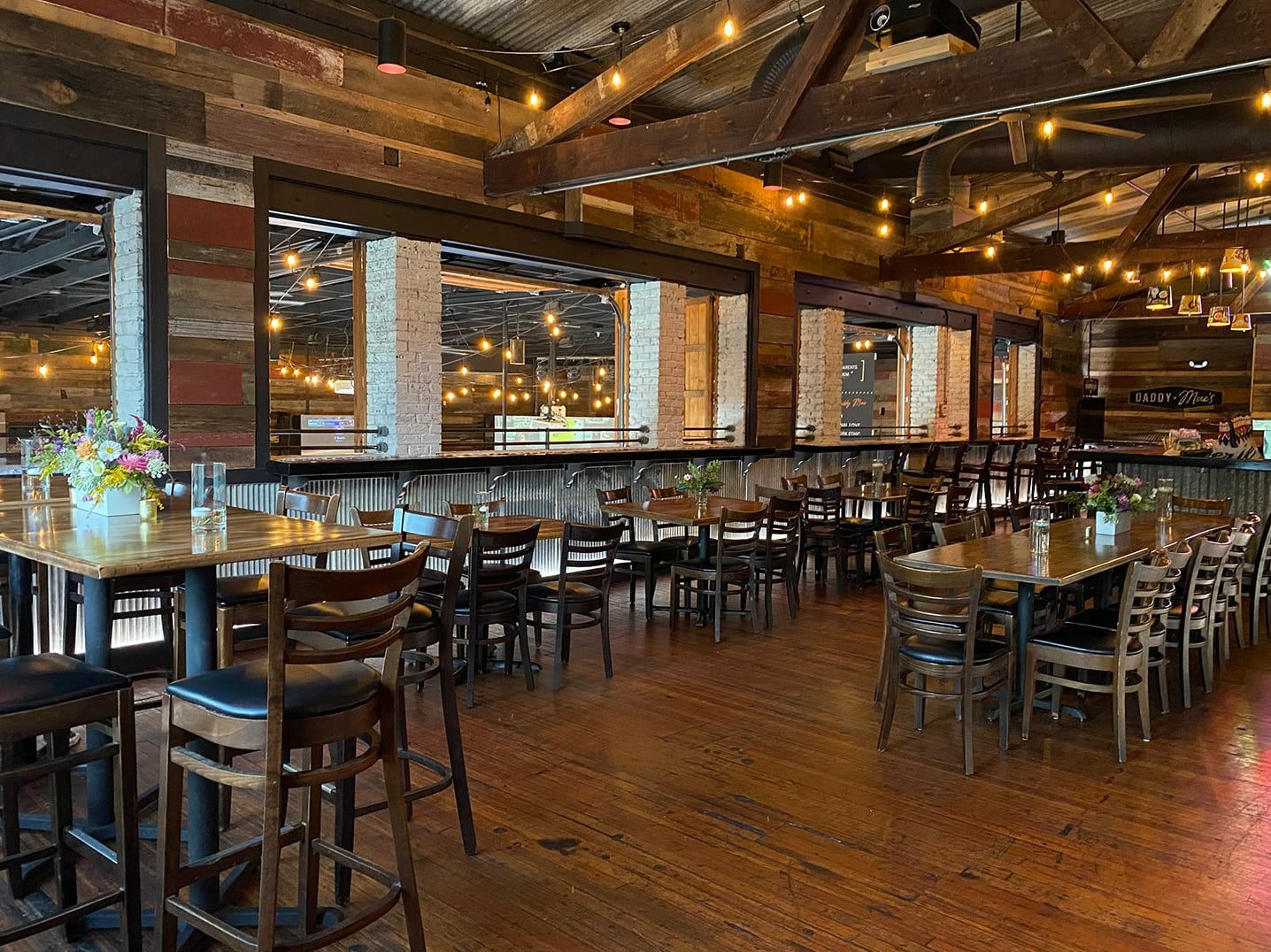 Rustic dining area with reclaimed wood walls and industrial-chic decor