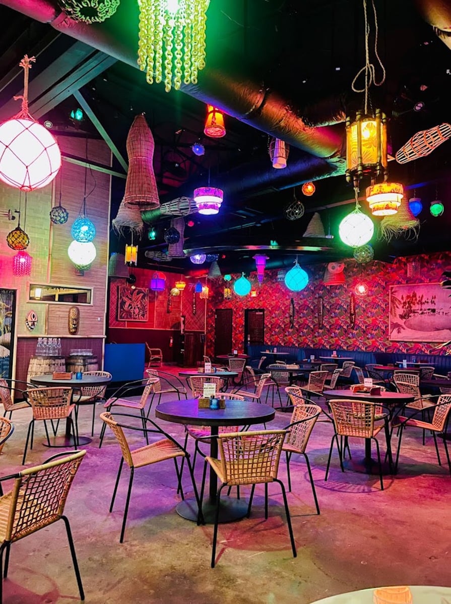 Colorful tiki interior with hanging lanterns and tropical decor