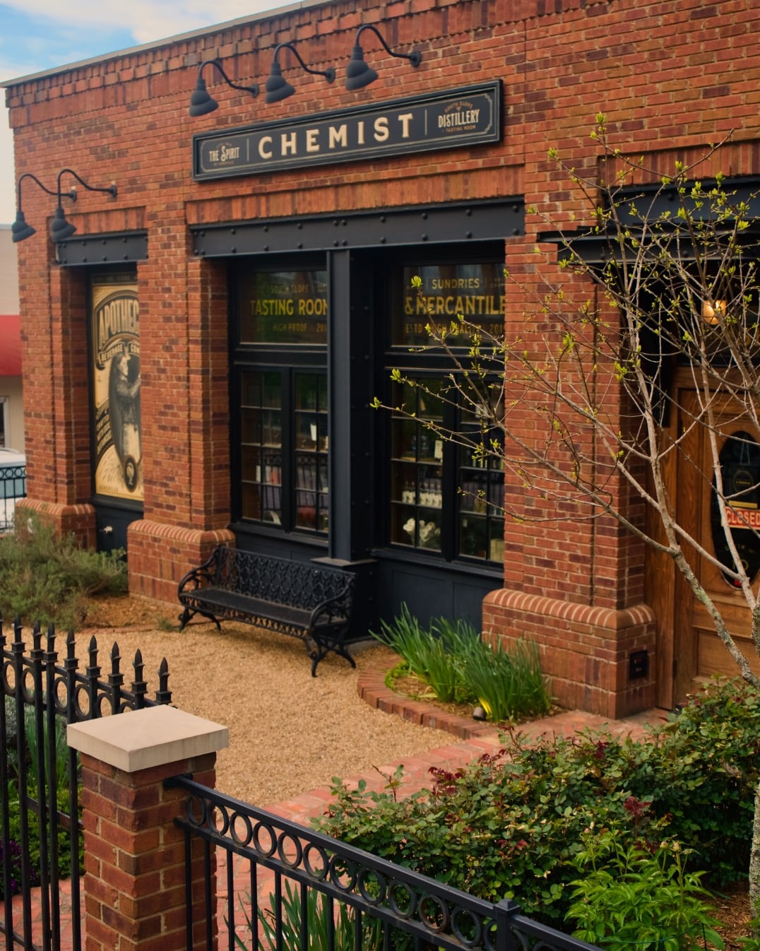 The Spirit Chemist Distillery welcoming exterior with brick facade and tasting room signage.