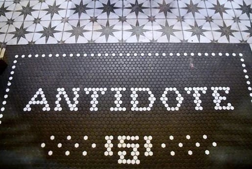 Antidote name spelled in vintage mosaic tile floor — a signature detail of the venue
