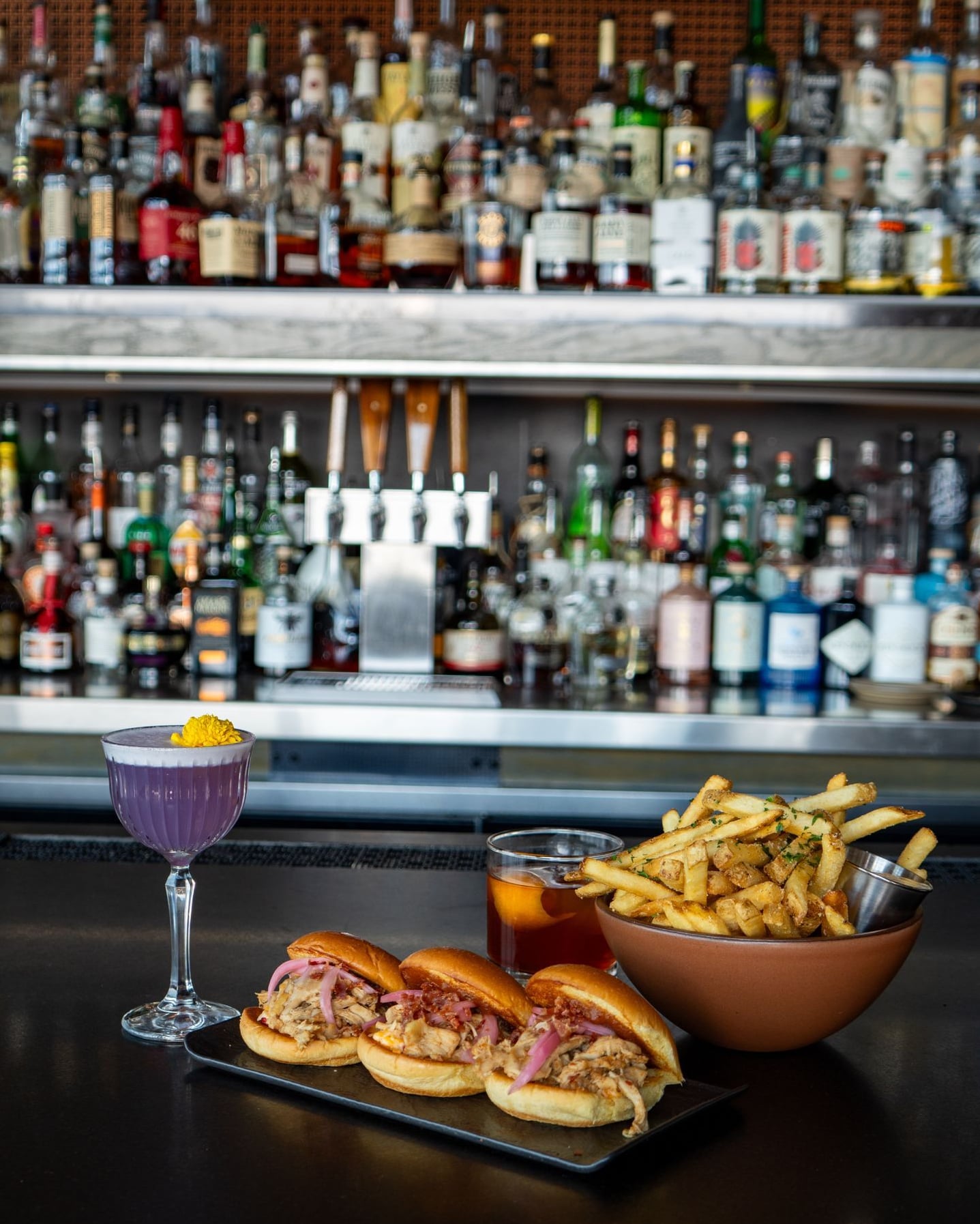 Purple cocktails and sliders served at the bar.
