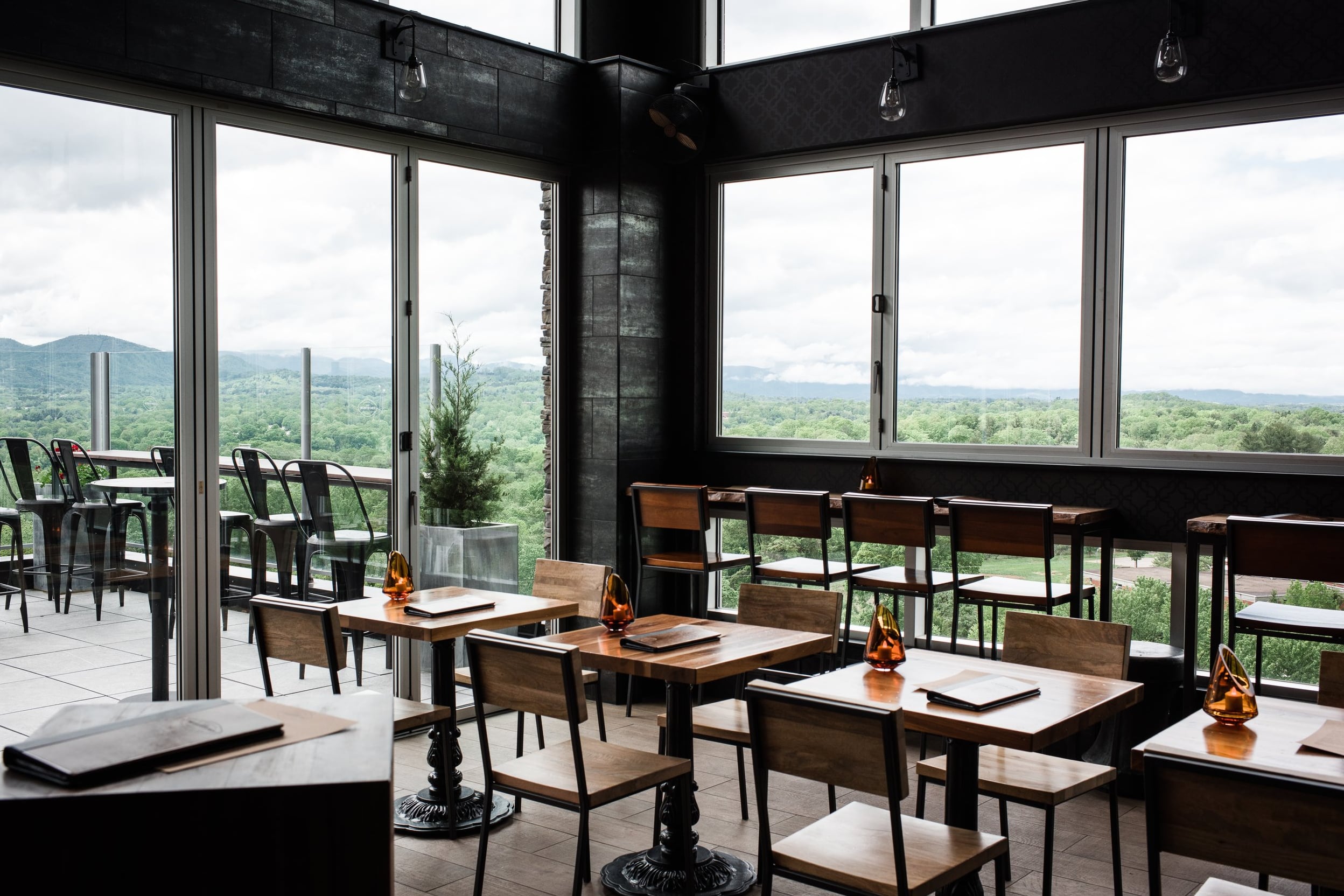 Contemporary interior with large windows featuring scenic mountain views.