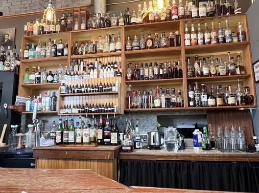 Impressive backbar shelves stocked with an extensive whiskey and spirits collection