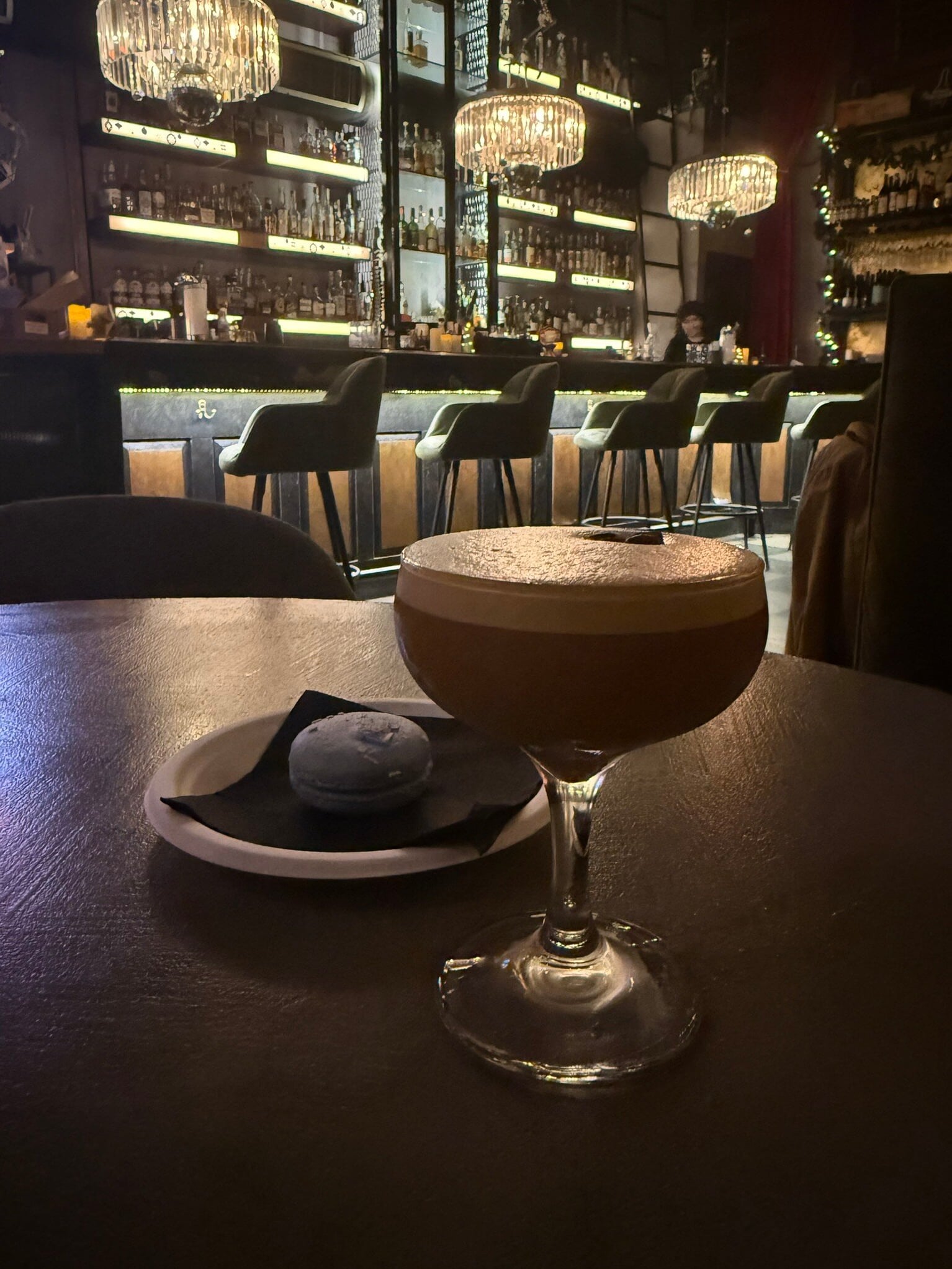 Signature cocktail with silky foam presented at the bar