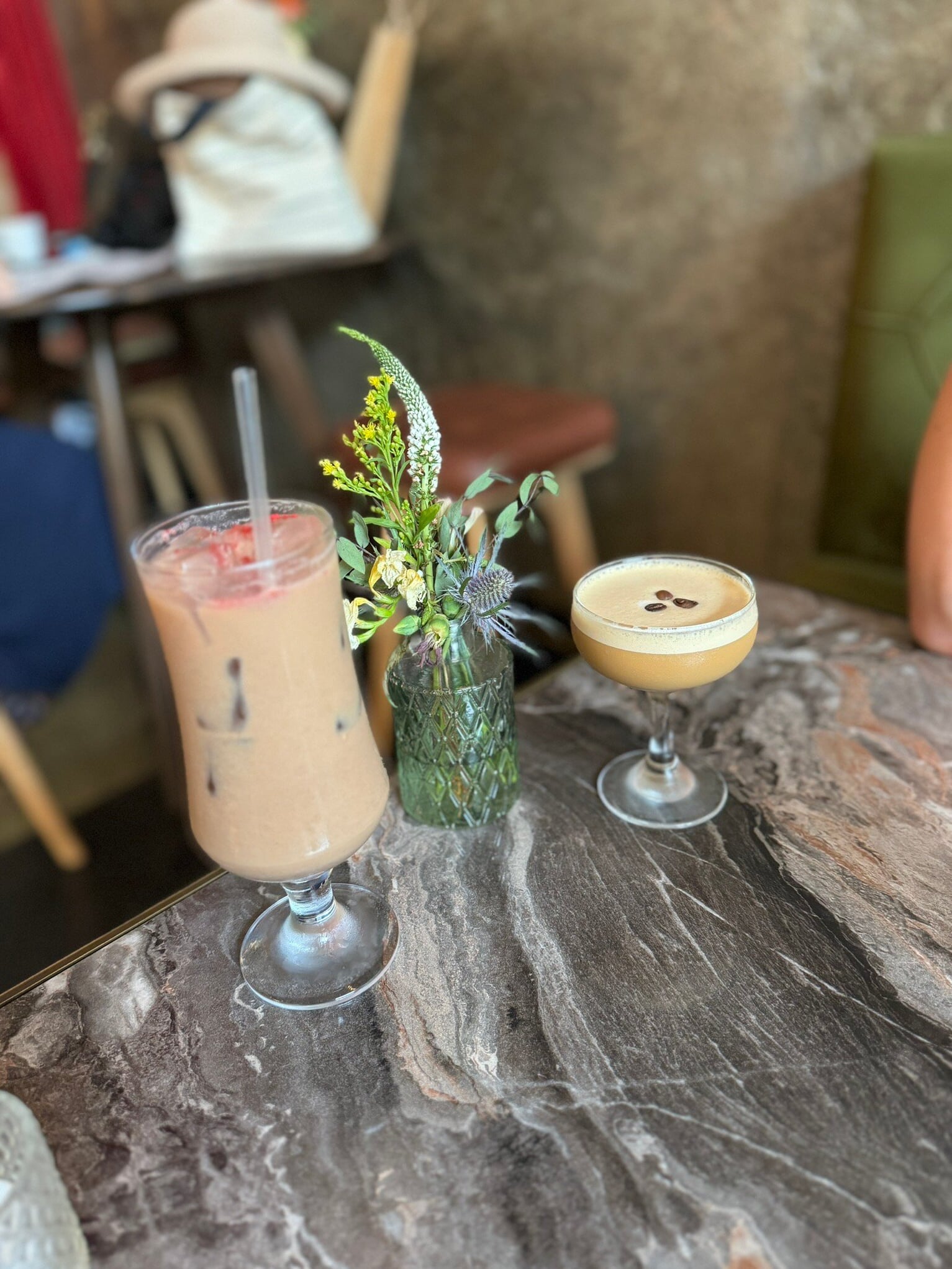Herb-garnished cocktail served on outdoor patio