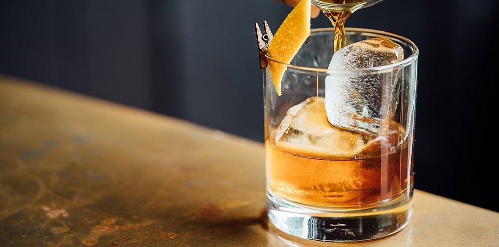 Signature cocktail with orange peel garnish