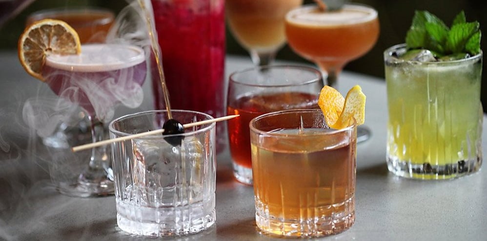 Assortment of signature cocktails with fresh garnishes