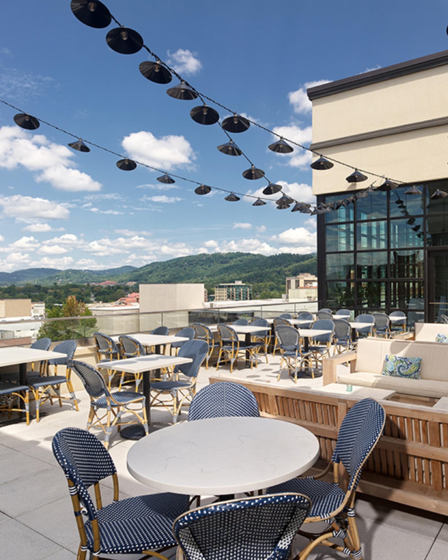 Rooftop terrace with scenic mountain views and bistro seating.
