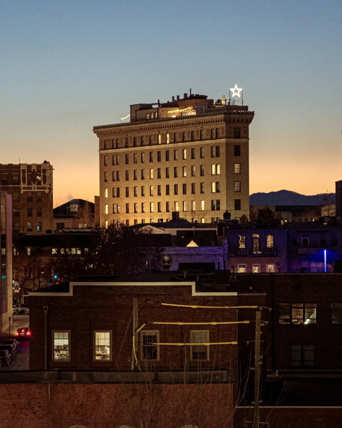 Historic exterior of the venue featuring rooftop star illumination at dusk
