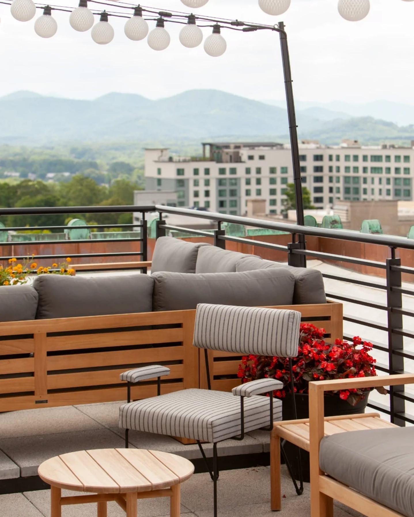 Scenic rooftop lounge featuring modern seating with mountain views
