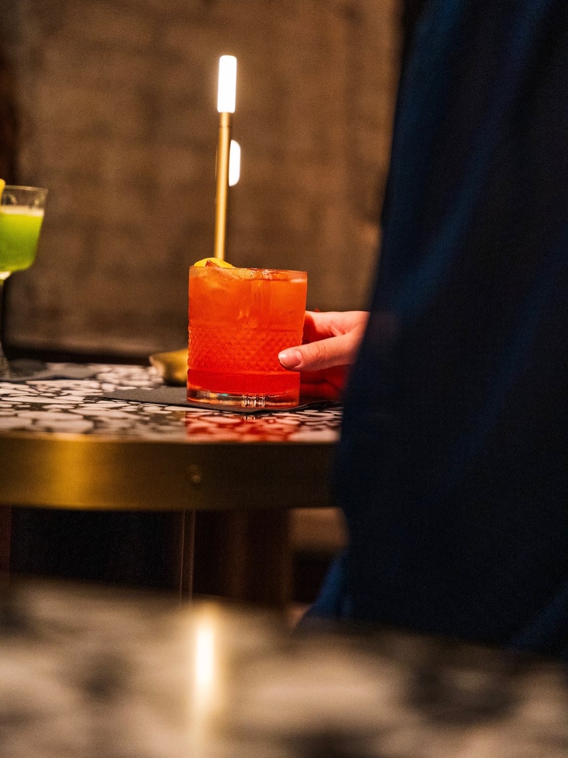 Signature cocktail with flaming garnish and modern presentation