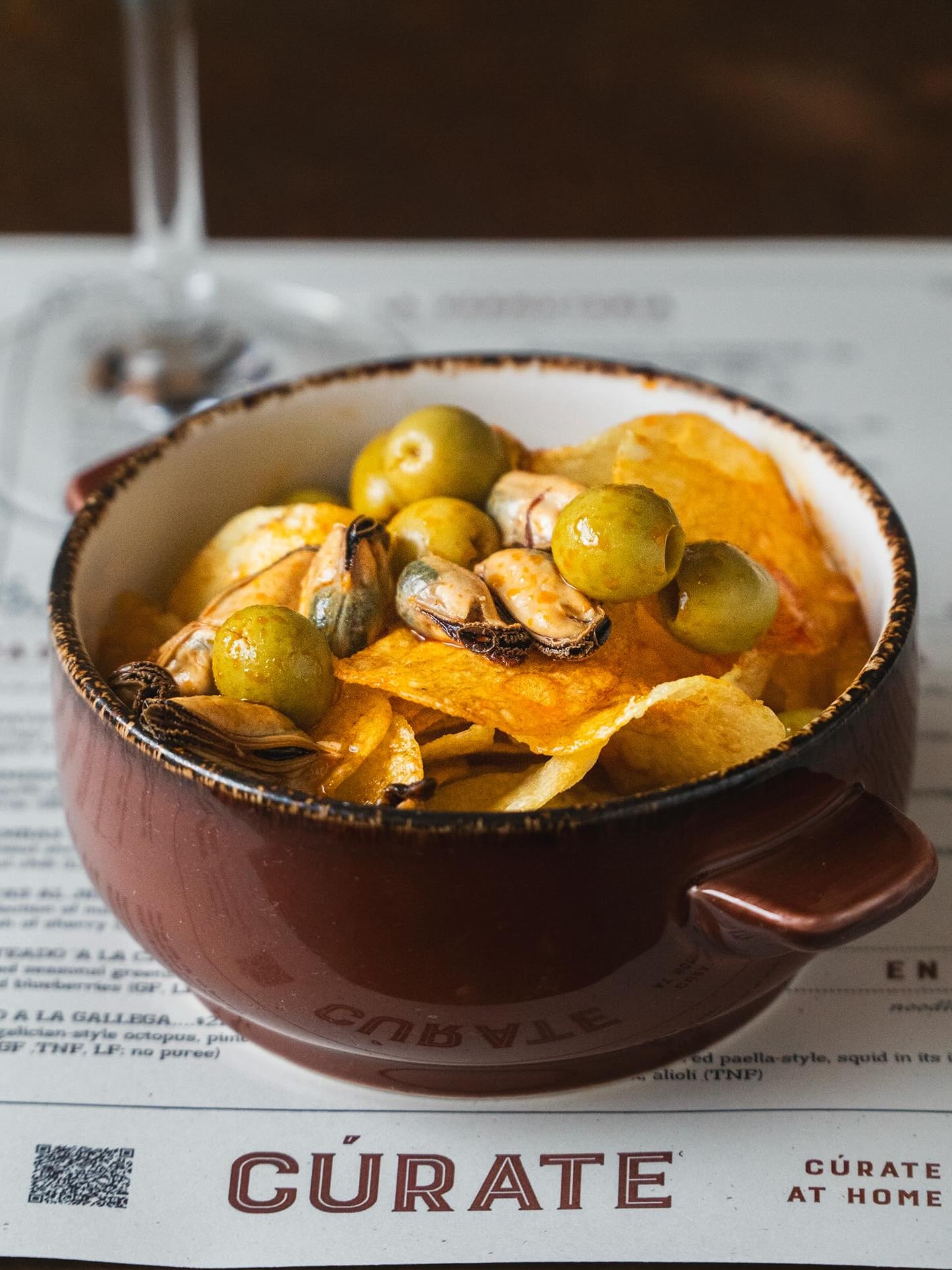 Baked mussels topped with olives and chippers at Cúrate