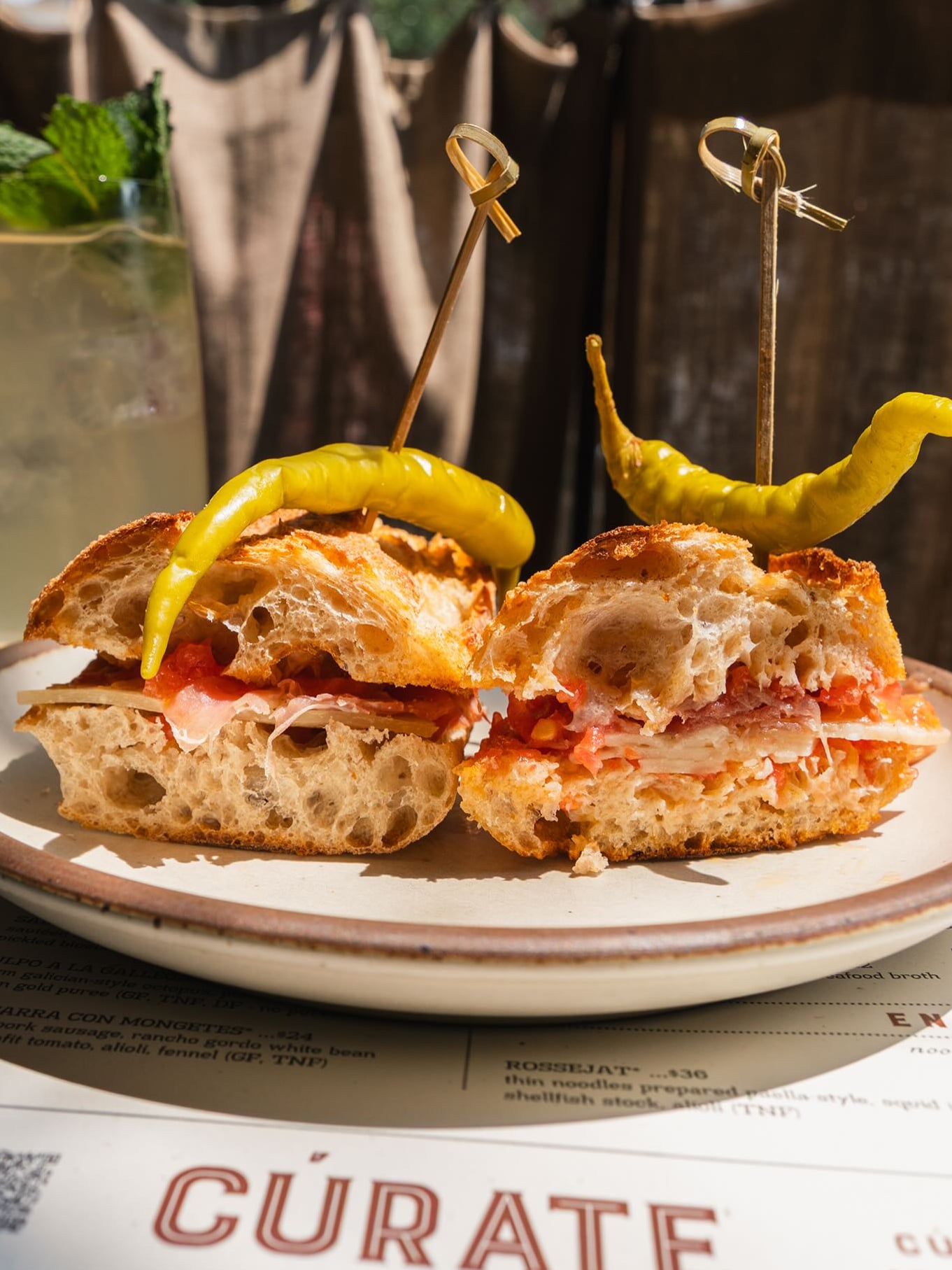Sandwich with house pickled peppers, served tableside with the Cúrate menu