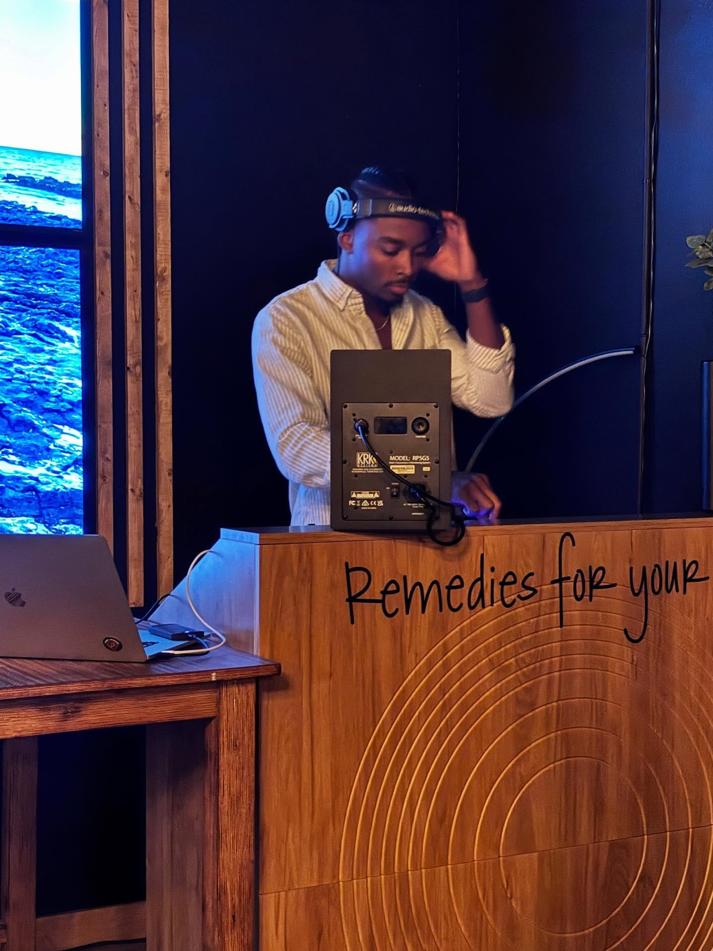 Live DJ at Farmese with stage lighting and distinctive wooden DJ booth