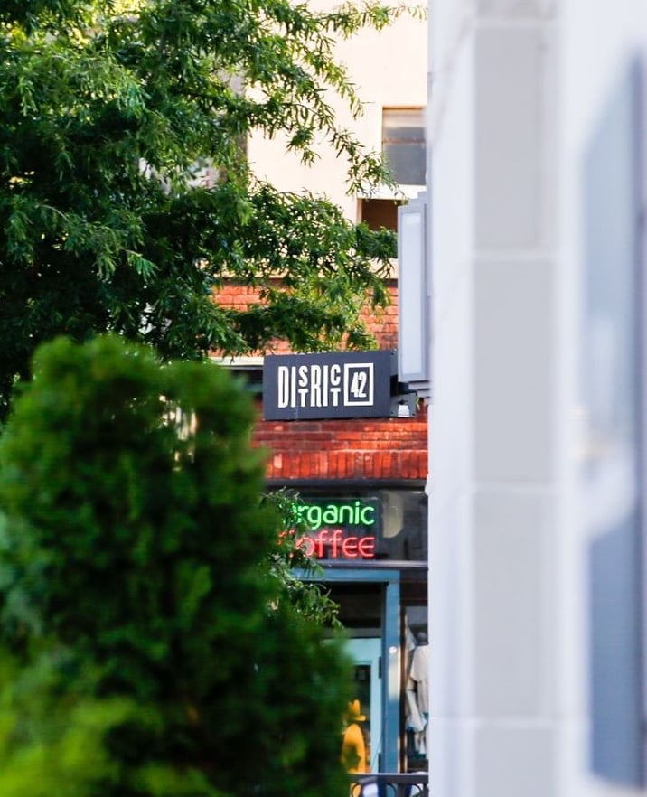 District 42 exterior signage featuring a modern black logo on a brick facade.
