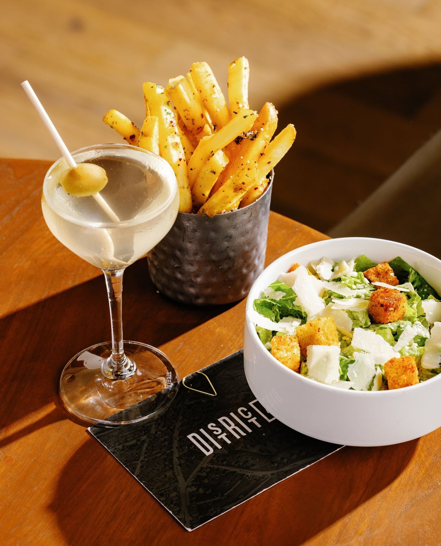 Classic martini served with seasoned fries and Caesar salad.