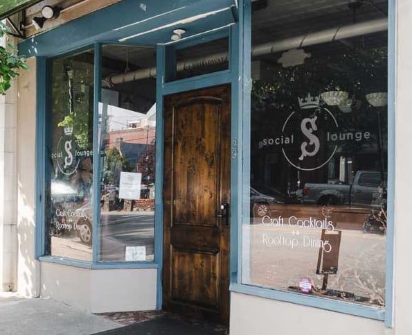The Social Lounge storefront on Broadway Street with signature logo and Craft Cocktails & Rooftop Dining signage.