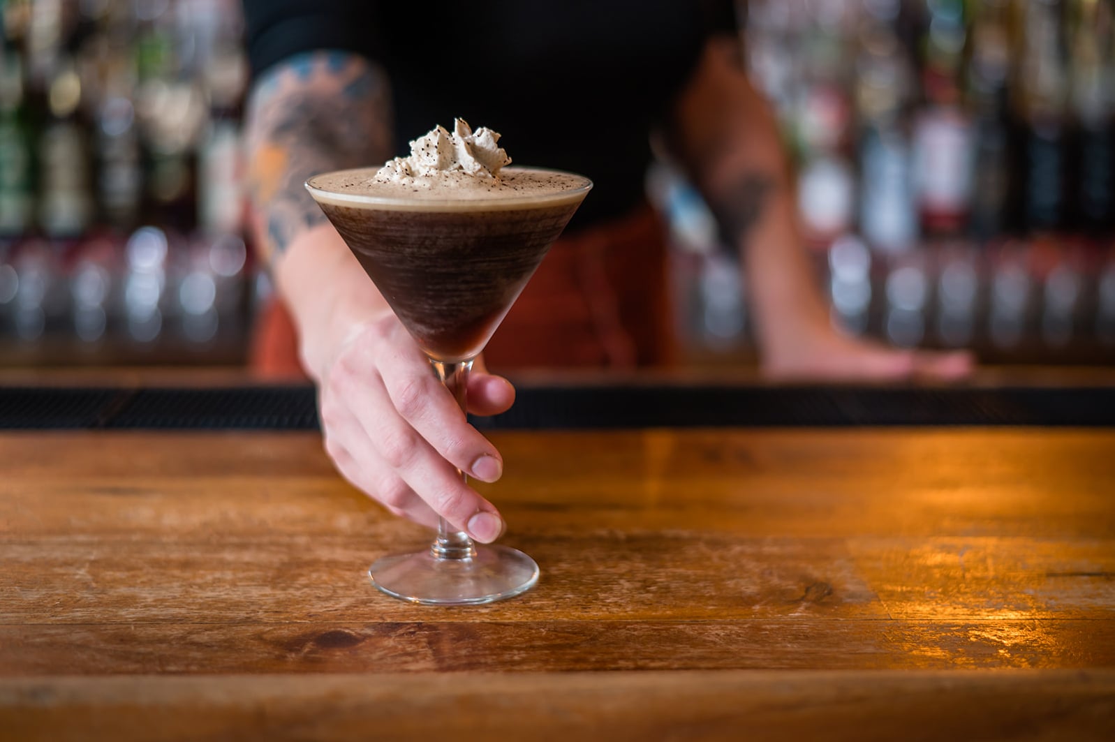 Handcrafted cocktail finished with fresh whipped cream served at the bar.