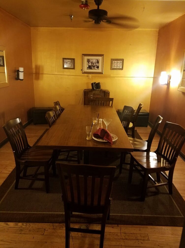 Cozy back dining room with vintage photos and warm lighting