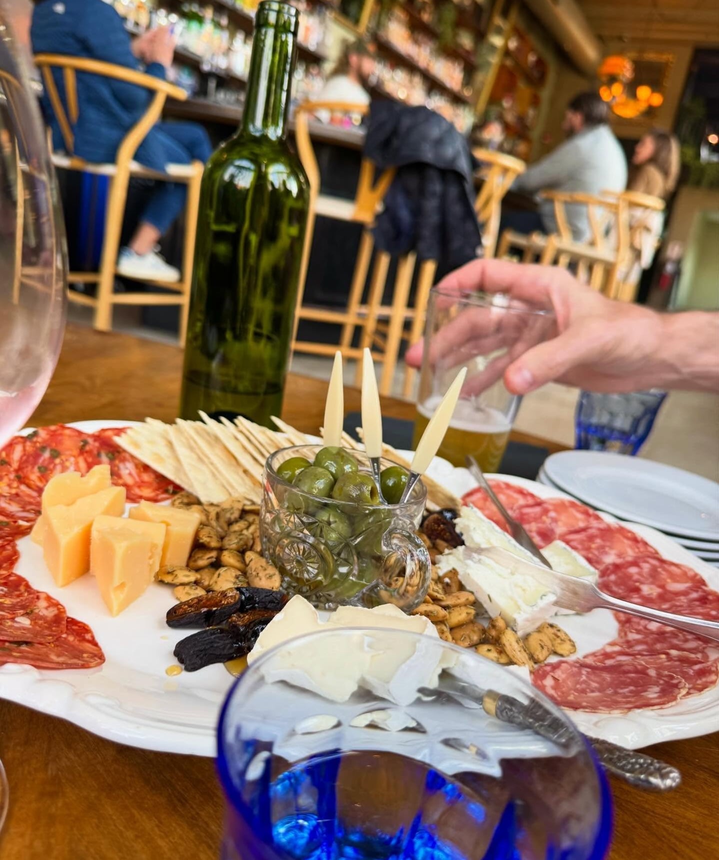 Large charcuterie and cheese board with wine and beer.