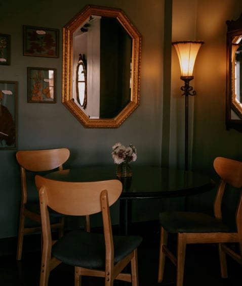 Intimate seating area with vintage decor and warm lighting.