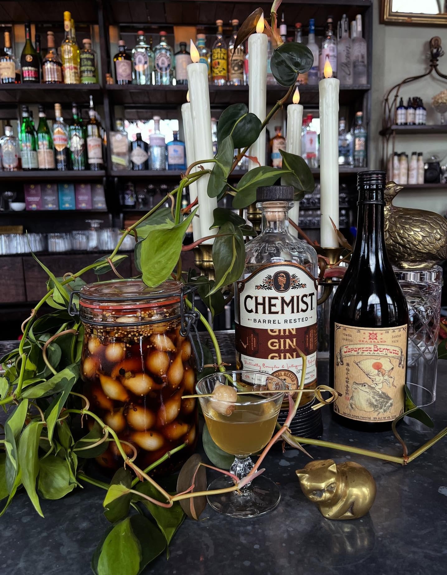 Artful cocktail presentation with Chemist Barrel Rested Gin and vintage bar decor.