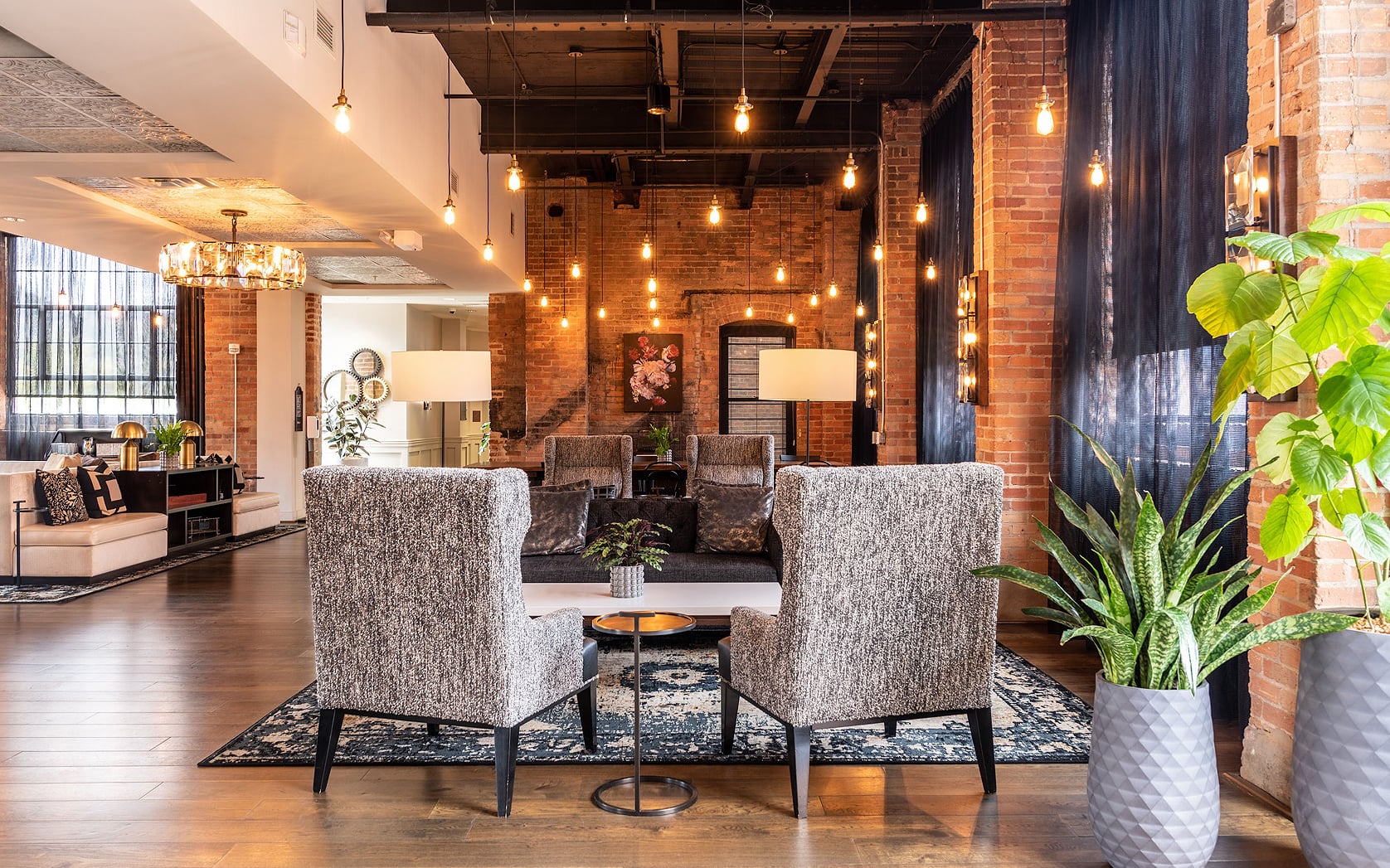 Industrial-chic interior with exposed brick and modern lounge furniture.