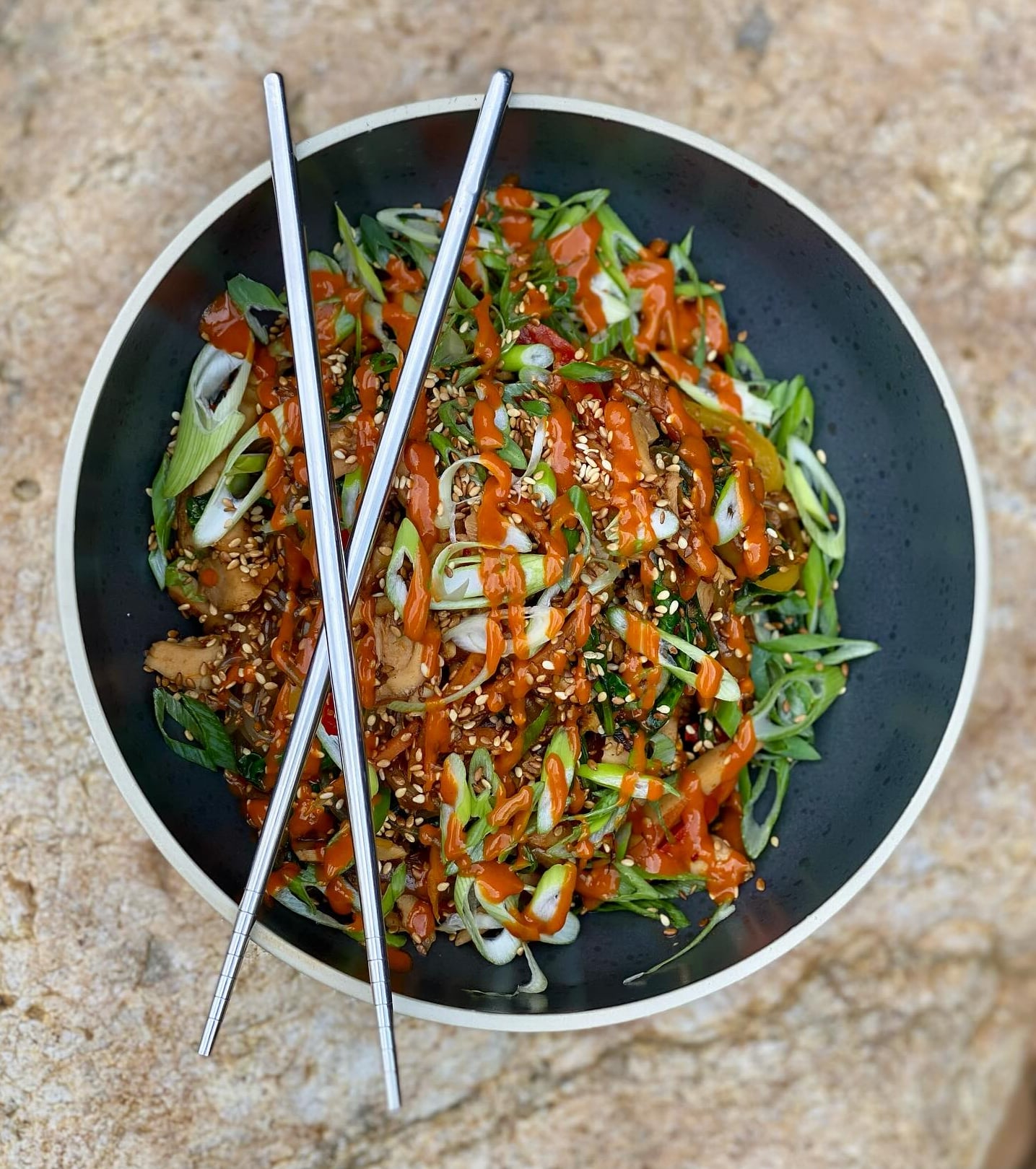 Stir-fried noodles with fresh greens and spicy sauce.