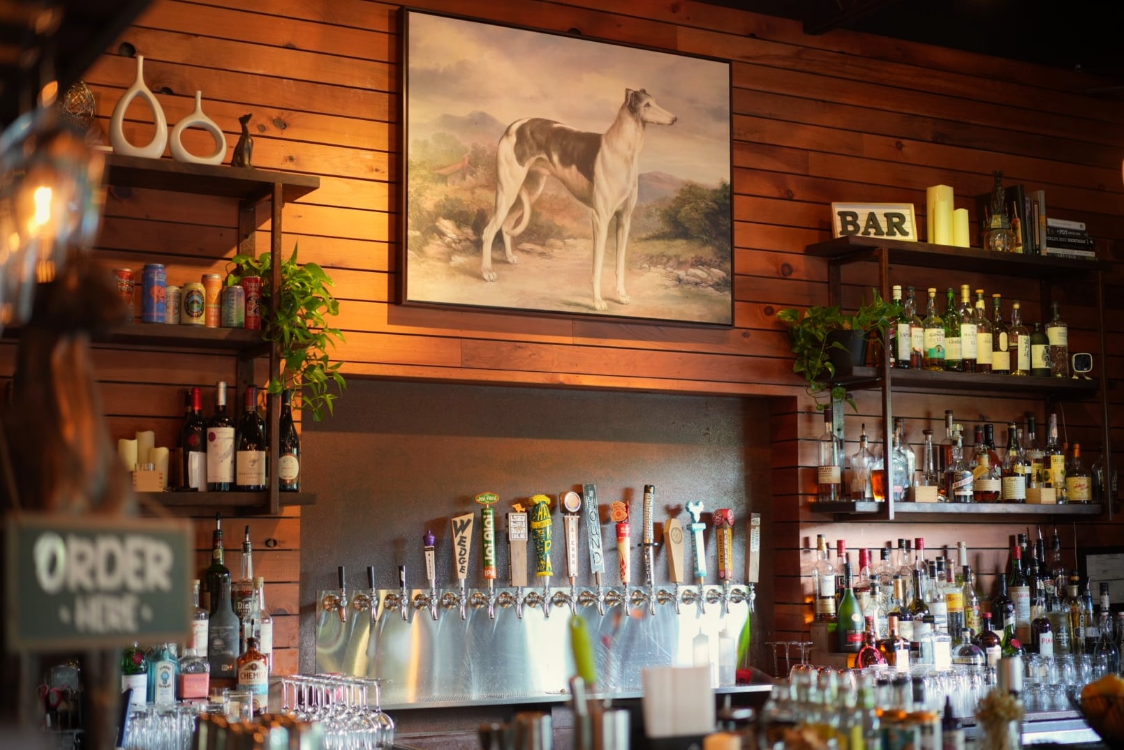 Extensive draught lineup at the backbar with wood-paneled walls.