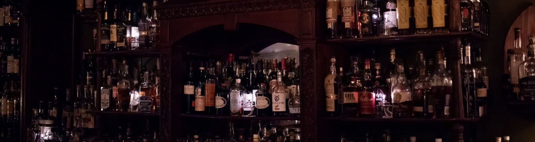 Extensive spirit selection behind an ornate wooden backbar.