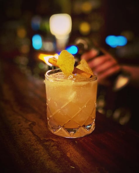Handcrafted specialty cocktail resting on the bar counter