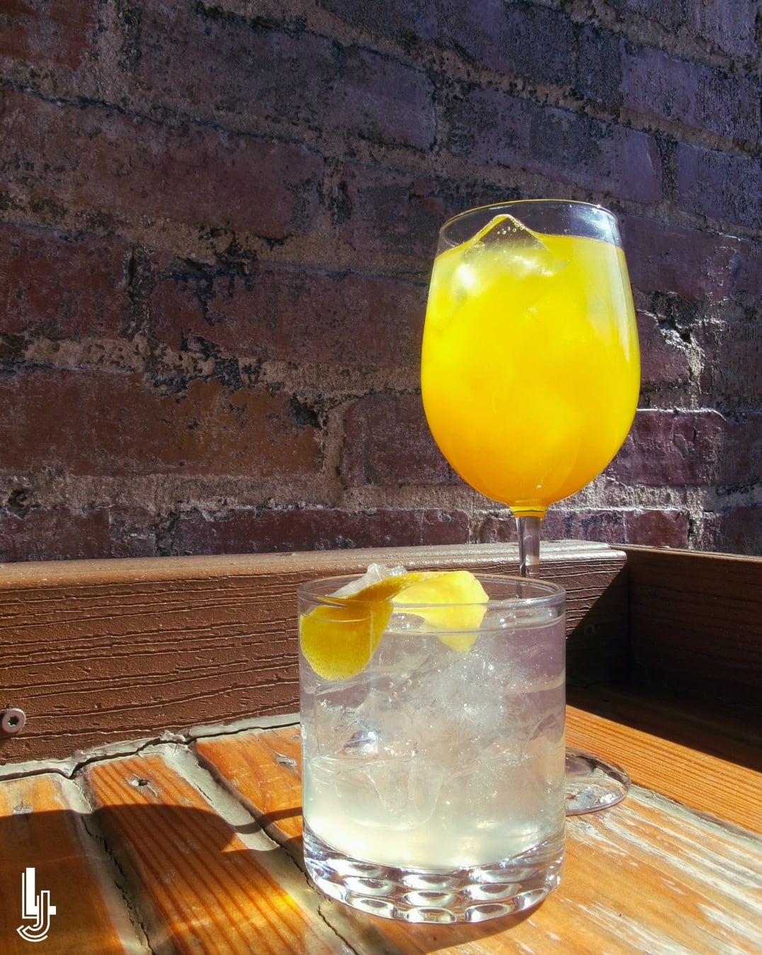 Colorful craft cocktails against our signature brick