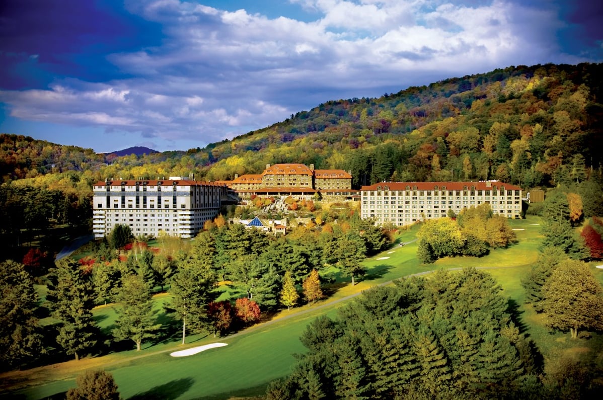 Aerial view of the Omni Grove Park Inn nestled in Blue Ridge Mountain fall foliage