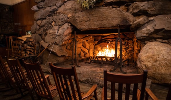 Rocking chairs gathered around the Great Hall's roaring stone fireplace