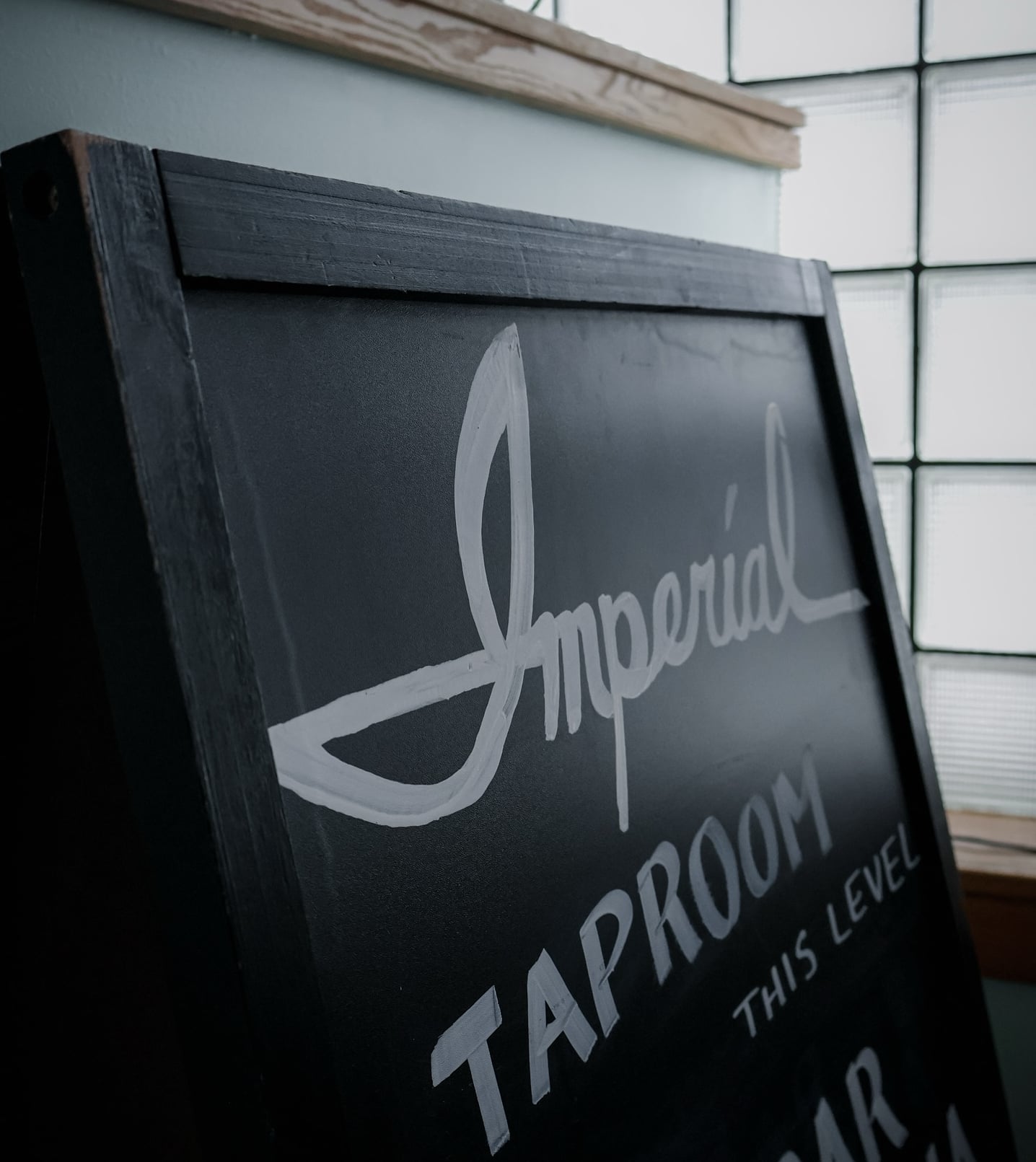 Hand-painted entrance sign guiding guests to the Imperial Taproom.