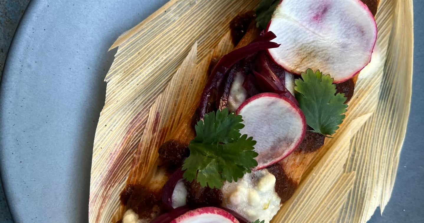 Gourmet tostada topped with fresh radishes, roasted beets, and cilantro.