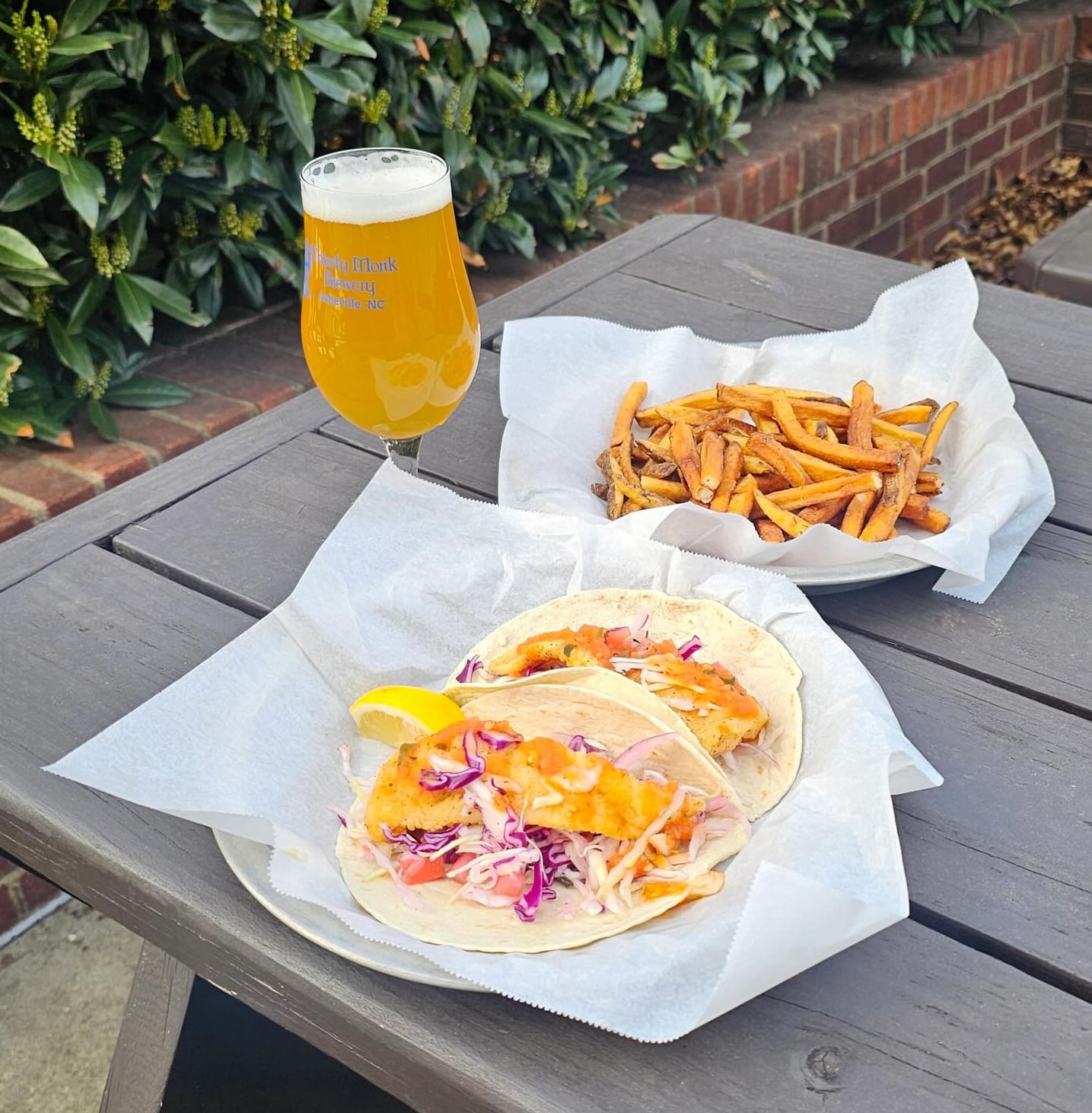 Fresh fish tacos and fries on the patio with cold beer